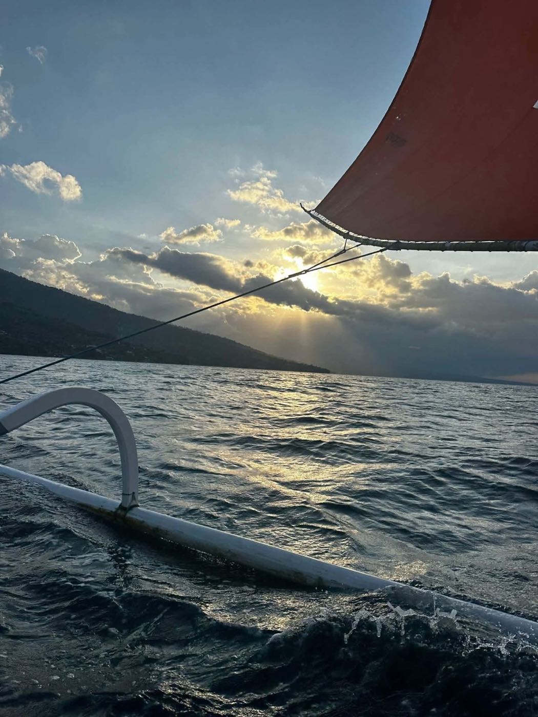 Sailing at sunset with the sail up